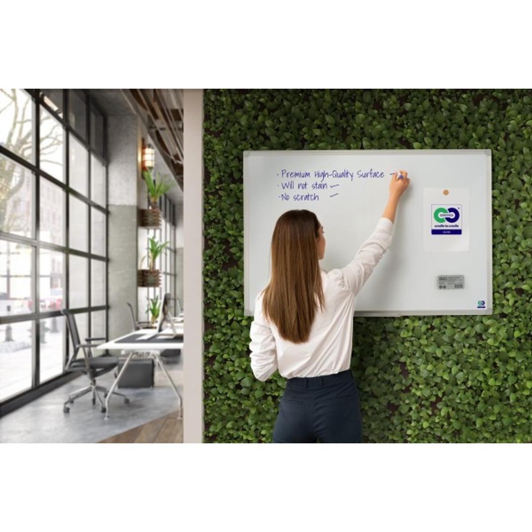 Tableau blanc Bi-Office Earth au mur, une femme y écrit au feutre