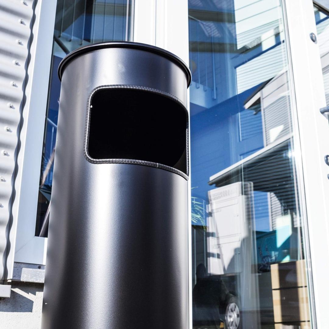 Cendrier-poubelle à couvercle étouffoir, 17 litres SAFE noir DURABLE - Cendrier-poubelle à couvercle étouffoir DURABLE SAFE noir, en situation à l'entrée d'un bâtiment